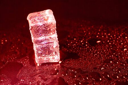 ice cubes on a reflections red light.の写真素材