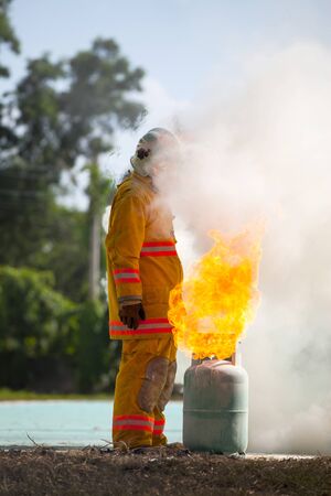 Firefighter with fire and suit for protect fire fighter for training firefighters.の写真素材