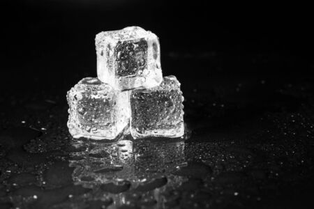 ice cubes on black table background.の写真素材