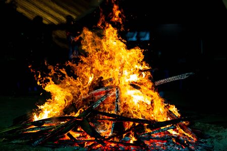 Bonfire that burns on a dark background, wood burning flame.