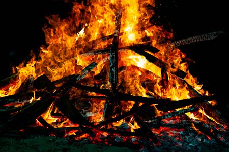 Bonfire that burns on a dark background, wood burning flame.の写真素材