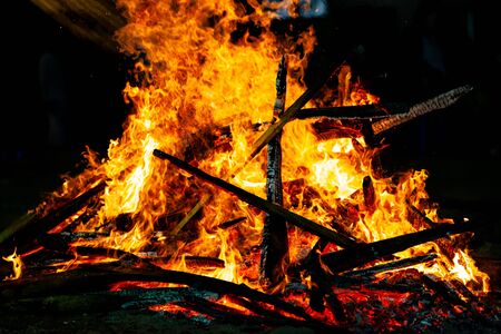 Bonfire that burns on a dark background, wood burning flame.の写真素材
