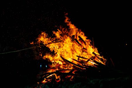 Bonfire that burns on a dark background, wood burning flame.の写真素材