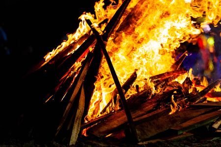 Bonfire that burns on a dark background, wood burning flame.