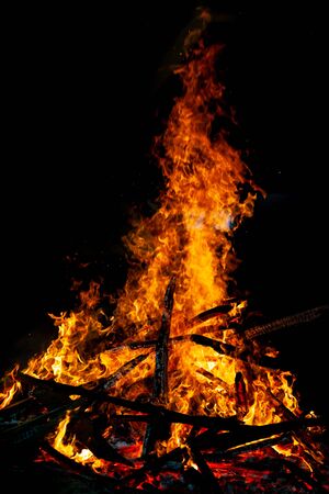 Bonfire that burns on a dark background, wood burning flame.の写真素材