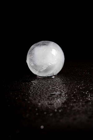 ice ball reflection on black background.の写真素材