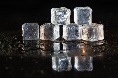 ice cubes reflection on black table background.の写真素材