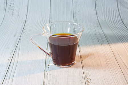 Cup of coffee on woody background.