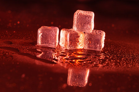 Red ice cubes on black background.の写真素材