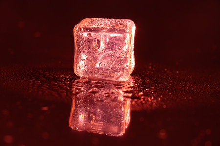 Red ice cubes on black background.の写真素材