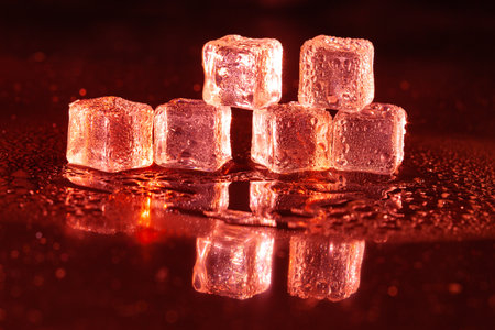 Red ice cubes on black background.の写真素材