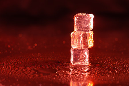 Red ice cubes on black background.の写真素材