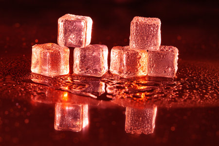 Red ice cubes on black background.の写真素材