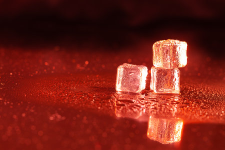 Red ice cubes on black background.の写真素材