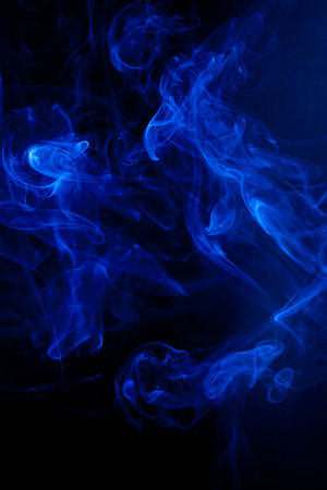 Blue smoke motion on black background.の写真素材