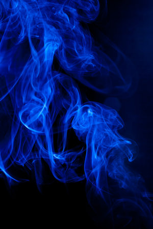 Blue smoke motion on black background.の写真素材