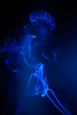 Blue smoke motion on black background.の写真素材