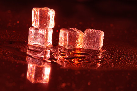 Red ice cubes on black background.の写真素材