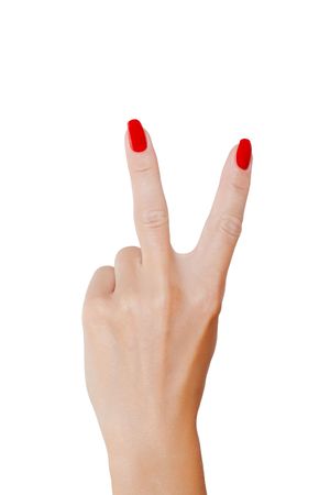 Victory sign. Elegant woman's hand with red nail polishの写真素材