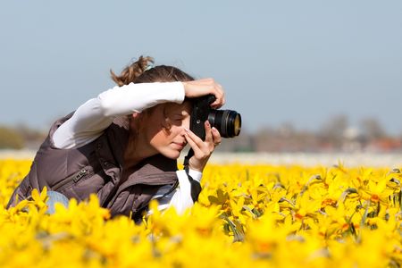 Girl photographer making pictures of flowers. Spring in the Netherlandsの写真素材