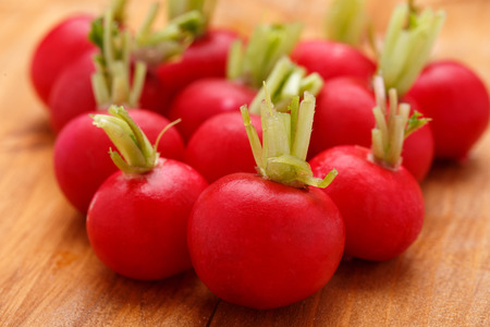 The fresh radishes on the wooden tableの写真素材