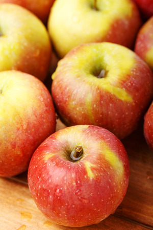 The red-green apples on the wooden tableの写真素材