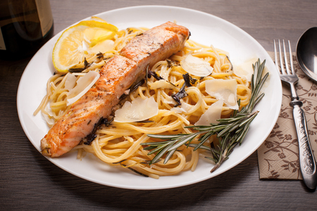 Pasta with salmon, parmesan and basil on the tableの写真素材