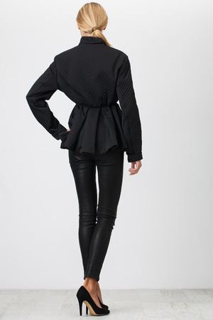Woman in the black pants on white backgroundの写真素材