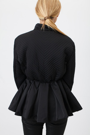 Young fashionable woman in black on white backgroundの写真素材