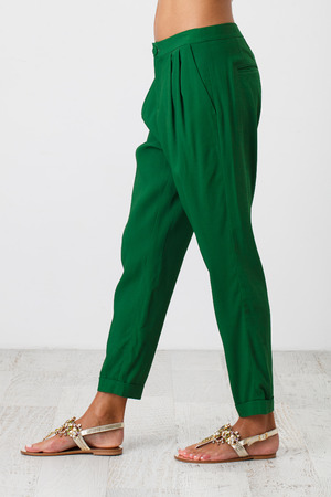 Woman in green summer pants on white backgroundの写真素材