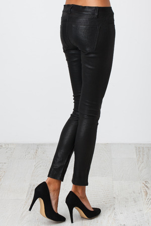 Woman in black pants on white backgroundの写真素材