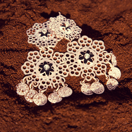 Close-up of the metal earrings in the spicesの写真素材