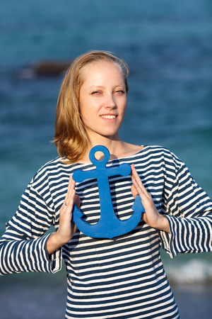 The young beautiful girl on a beach with an anchorの写真素材
