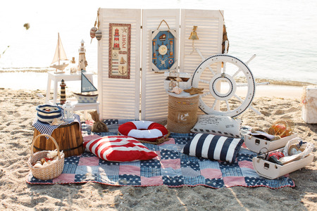 Decorative boats and lighthouses on the beachの写真素材