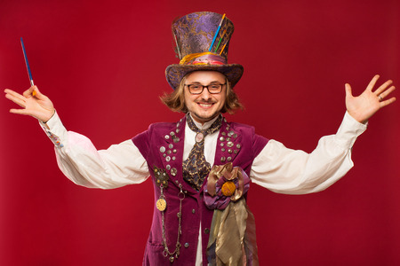 The man in a suit of illusionist-conjurer on red backroundの写真素材