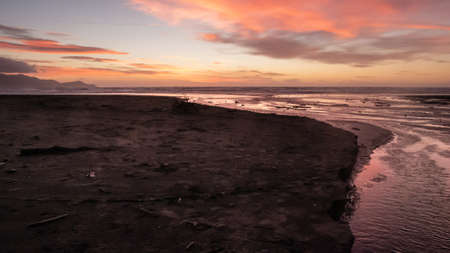 Purple sunset shot on the Kapiti coast beach,Near Paraparaumu in Wellington area, North Island of...