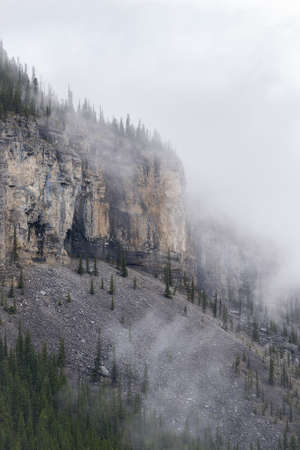 Detail of the mountain shrouded by clouds. Shot in Canadian Rockies on Kananaskis Ice Cave Trail, Alberta, Canadaの写真素材