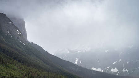 Storm clouds rolling into alpine valley, shot at Upper Kananaskis Lake, Alberta, Canadaの写真素材