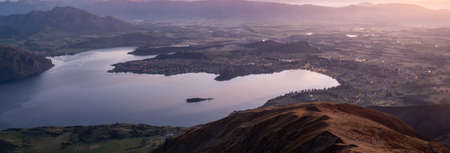 View on valley with lake during sunrise. Shot made on Roys Peak summit in Wanaka, New Zealandの写真素材