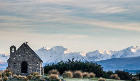 Small church with mountain backdrop shot during sunrise at Lake Tekapo, New Zealandの写真素材