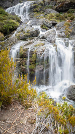 Cascading waterfall with silky water, portrait shot made on Routeburn Track, New Zealandの写真素材