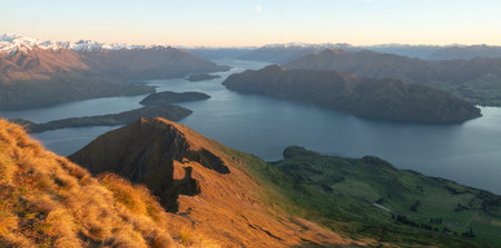 View on lake from mountain summit during sunrise, shot made on Roys Peak in Wanaka, New Zealandの写真素材