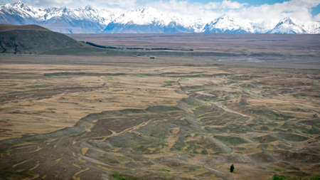 Landscape formed by glacier with snowy mountains in backdrop, shot at Tekapo, New Zealandの写真素材
