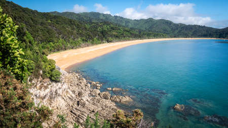 View on the tropical beach with golden sands and azure waters. Landscape shot made in Abel Tasman National Park, New Zealandの写真素材