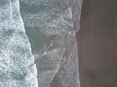 Waves and beach aerial shot from bird eye view. Made in Christchurch, New Zealand