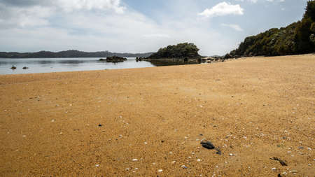 Remote beach with orange sand. Shot made on Ulva Island, Stewart Island Rakiura area, New Zealandの写真素材