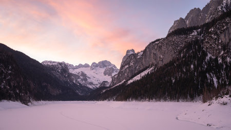 Colorful sunrise sky above snowy landscape with mountains during winter in Austrian Alps, Europe