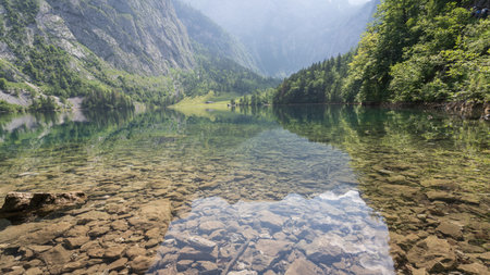 Crystal clear alpine lake surrounded by beautiful nature, wide view, Obersee, Germanyの写真素材