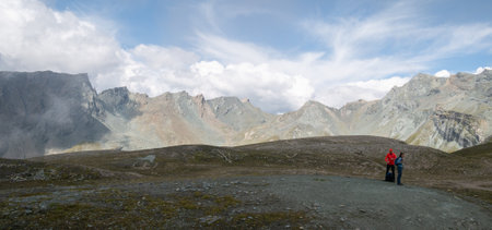 Hikers taking a break in alpine environment surrounded by rocky peaks, Austrian Alps, Europeの写真素材
