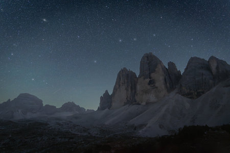 Night sky above massive rock formation, Tre Cime mountains, Dolomites, Italyの写真素材